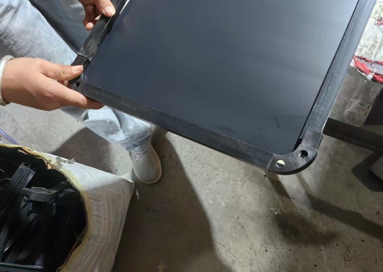 Moulded corner cap being fitted and screwed to a mirror frame