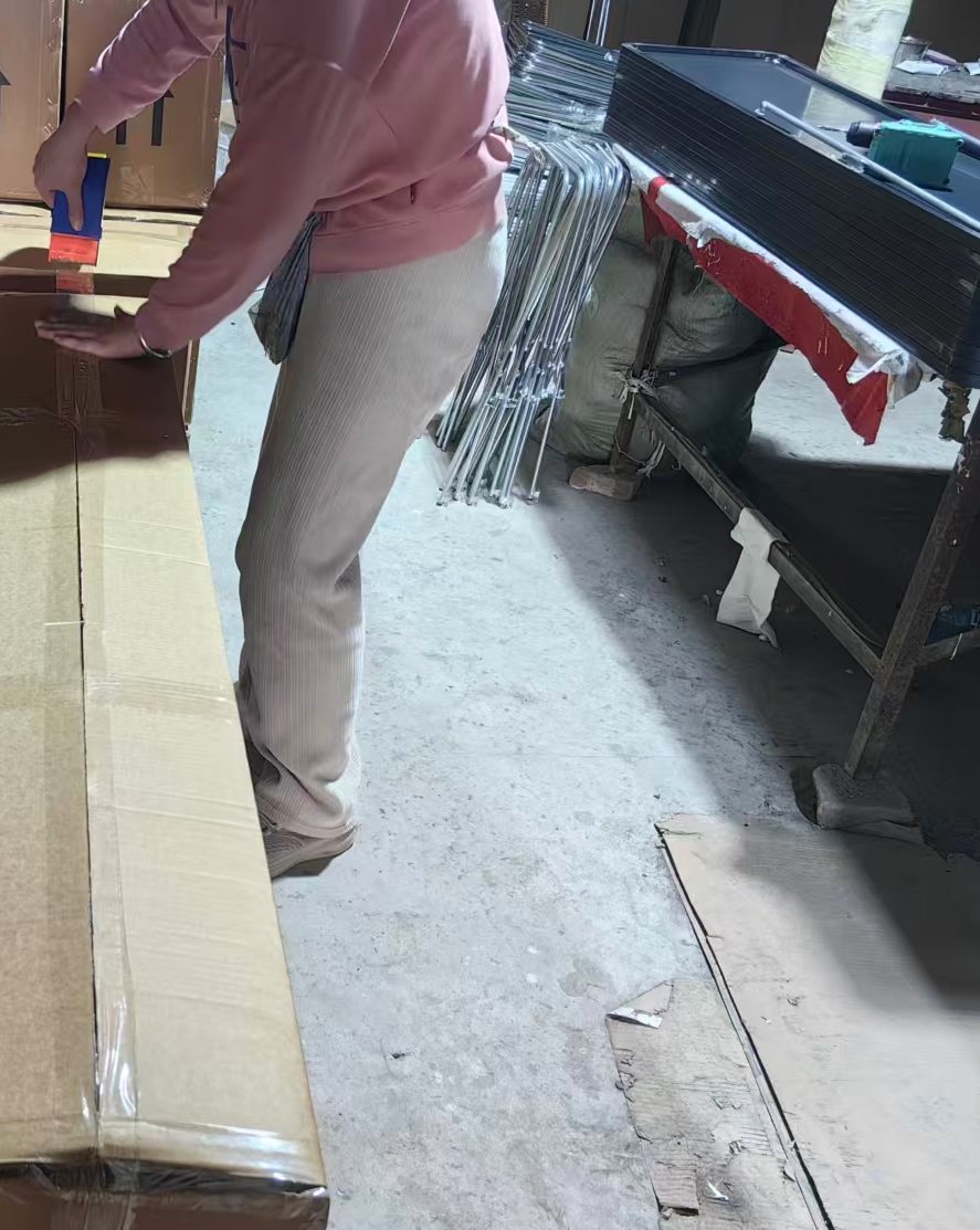 Packing station where full-length mirror cartons are sealed