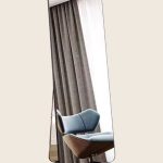 Freestanding full-length mirror with a slim black frame and folding rear easel