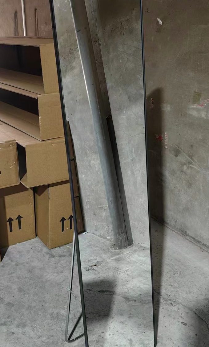 Front of the full-length mirror standing on its folding easel in the workshop