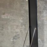 Side view of a full-length mirror with the folding metal easel stand open